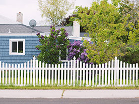 Zaun Planung - blaues Haus mit weißem Vorgartenzaun